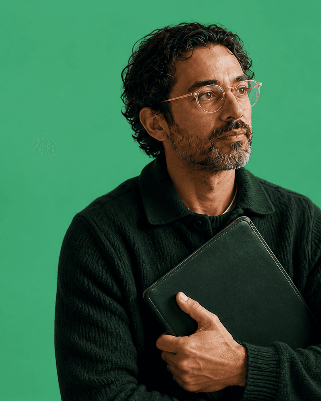 A person holding a green folio